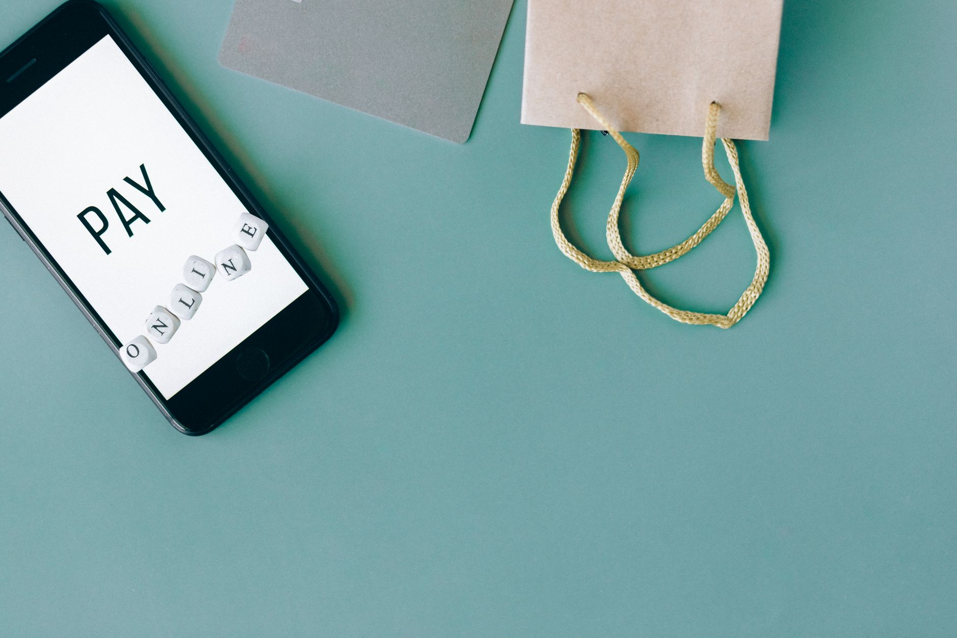 Woman browsing handmade digital products on a smartphone with craft items nearby