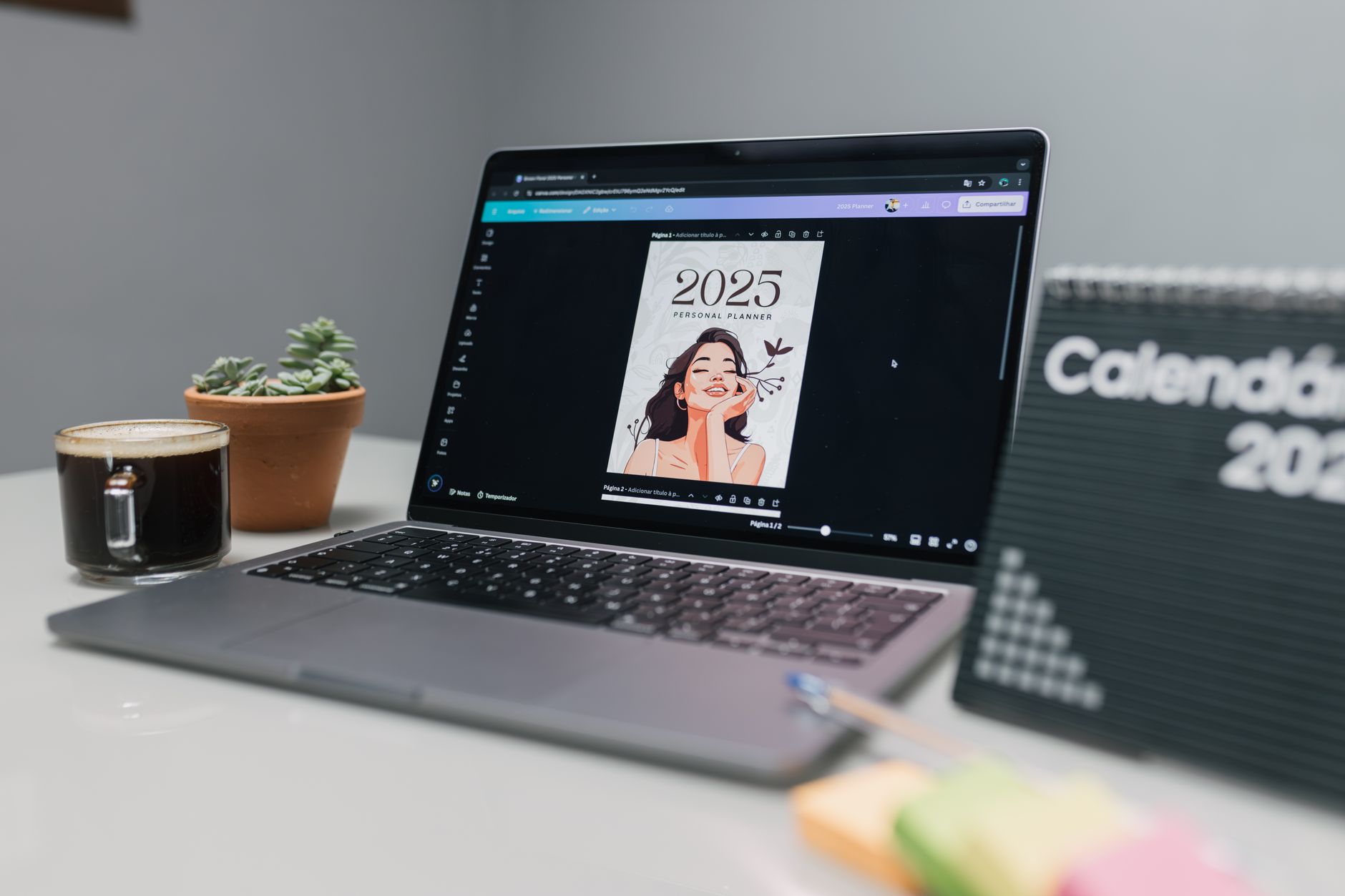 a person designing a digital planner in Canva on a laptop with a colorful template on screen