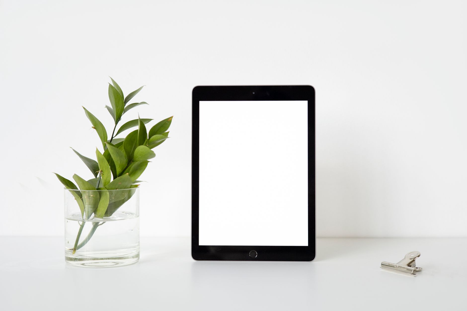 a tablet displaying a Canva template mockup on a desk next to a coffee cup