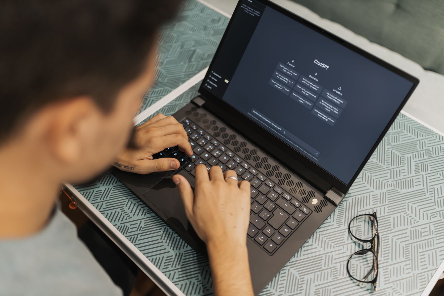 a person using a laptop with an AI image generator interface open on the screen