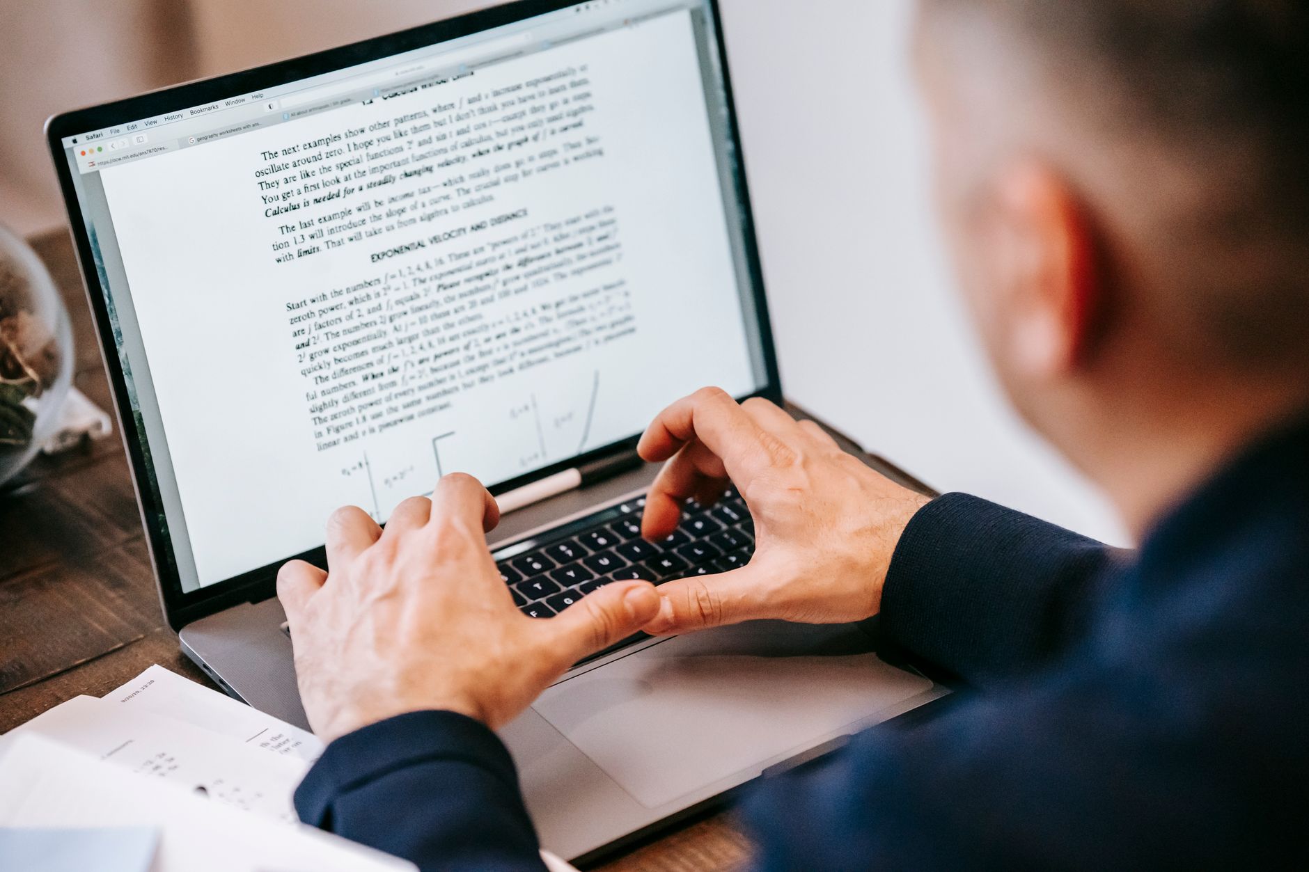 Person editing a long document on a computer screen