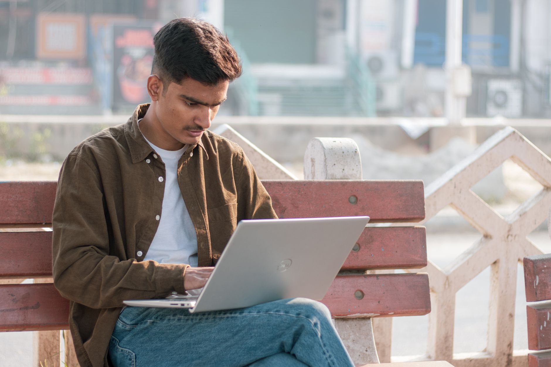 a creator making a product listing on a laptop with a Gumroad page visible